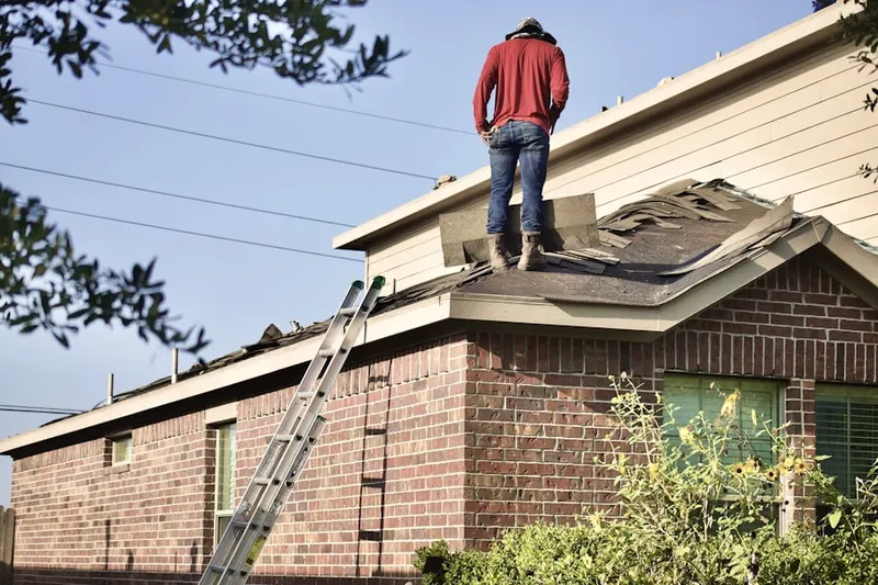 Professional roofer working on a residential roof in Hanson Park